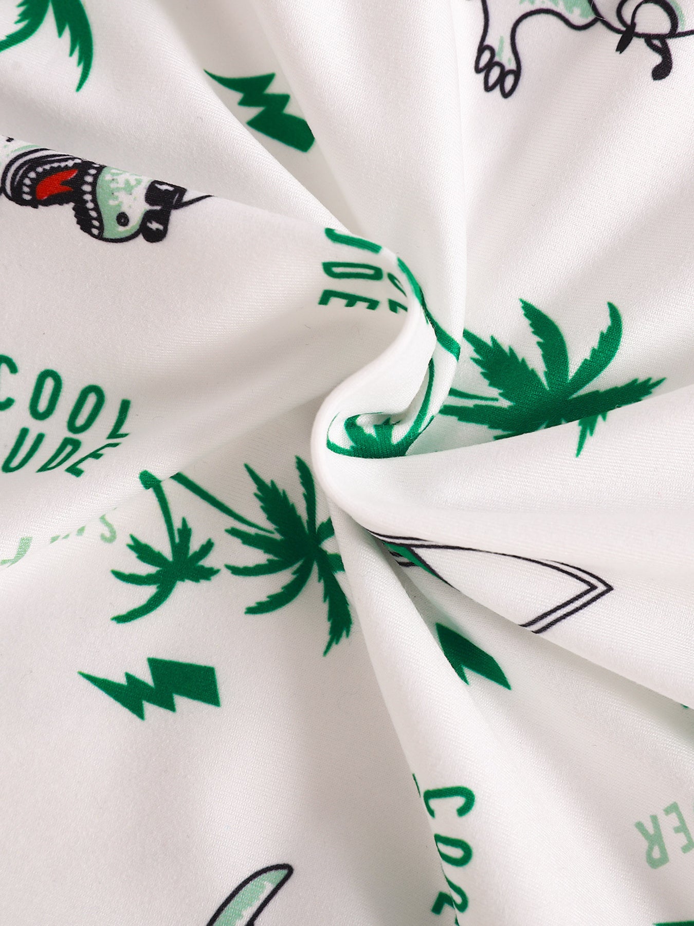 Baby polo and shorts set fabric with white background, green dinosaur, palm tree, and text print.