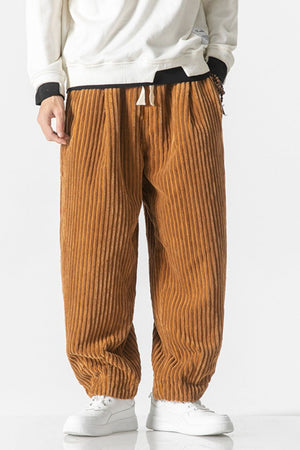 Orange corduroy wide-leg cargo pants with drawstring waist and vertical wale texture.