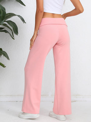 Blush pink palazzo trousers with a fold-over waistband and wide leg.