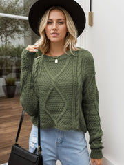 Moss green acrylic cable knit cropped sweater with diamond pattern detail.