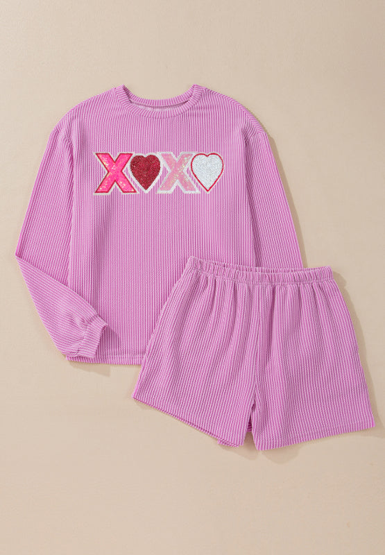 Pink textured loungewear set with XOXO graphic and heart details.