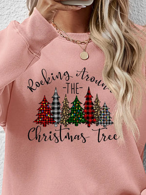 Blush pink crewneck sweatshirt with a graphic Christmas tree pattern and text.