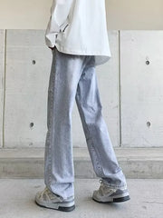 Men's light wash wide-leg jeans with vintage detailing.