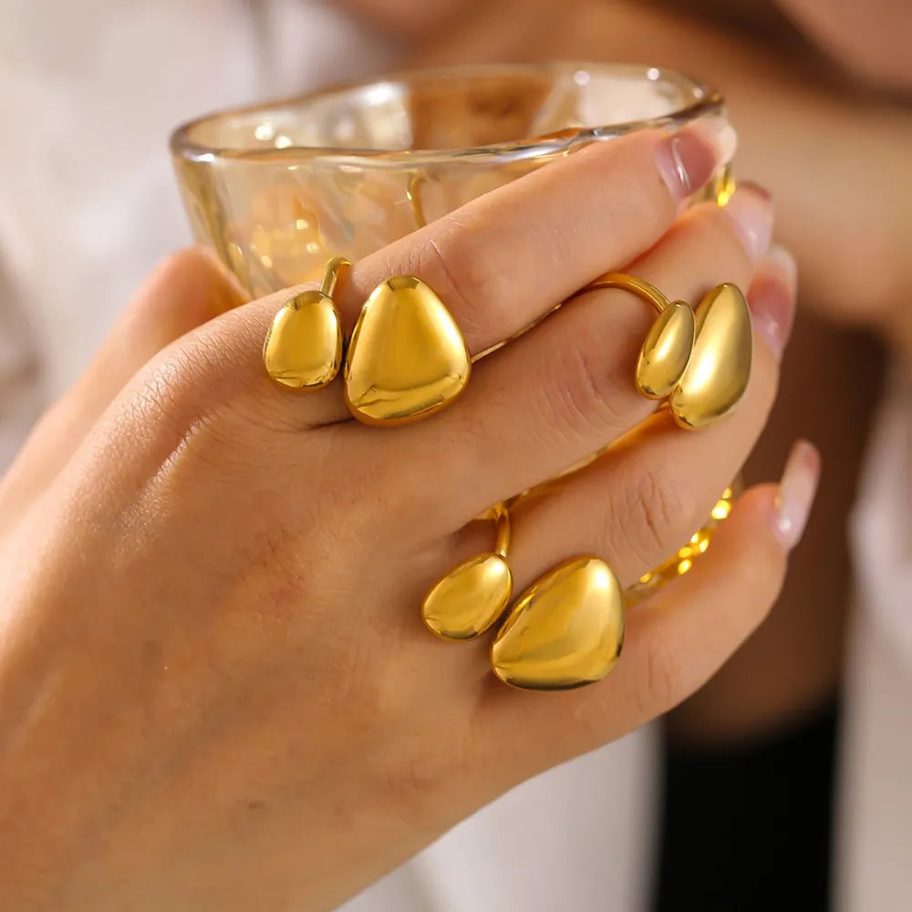 Gold bypass ring with sculptural pebble details.
