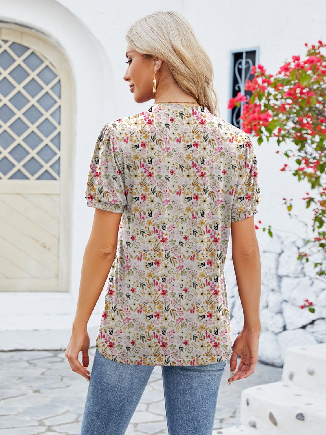 Floral print blouse with short sleeves and a keyhole neckline, shown from the back.