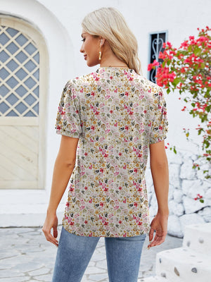 Floral print blouse with short sleeves and a keyhole neckline, shown from the back.