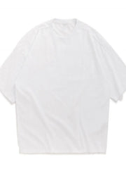 Oversized white crew neck t-shirt with textured fabric and short sleeves.