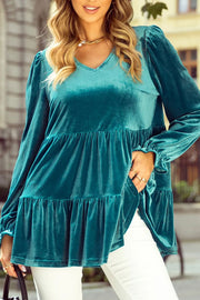 Turquoise velvet tiered blouse with puffed sleeves and V-neck.