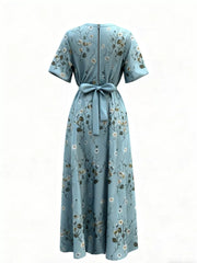 Teal floral maxi dress with short sleeves, defined waist tie, and back zipper.