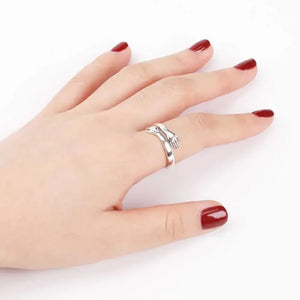 Hugging hands sterling silver ring with adjustable band.