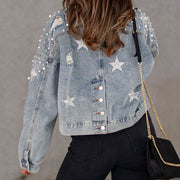 Light denim jacket with pearl embellishments and star patches, distressed details.