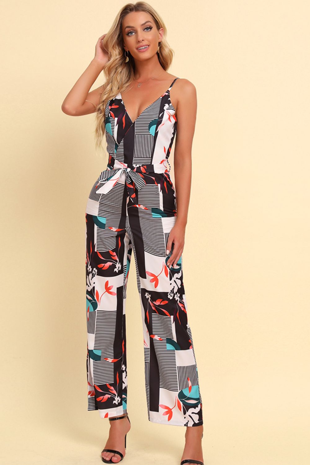 Geometric print cami jumpsuit with tie waist in white, featuring a V-neck and wide legs.