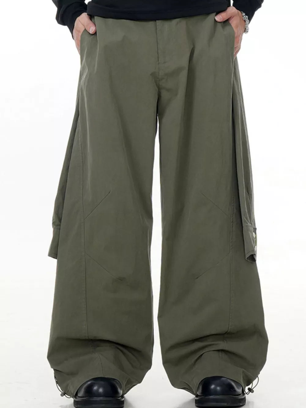 Army green wide-legged cargo pants with buttoned flap pockets and drawstring cuffs.