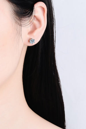 Silver six-prong solitaire stud earrings with a sparkling blue center stone.