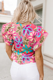 Floral ruffle sleeve silk blouse with pink trim and vibrant floral print.