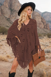 Brown knit poncho with geometric cutouts and fringe, featuring a tie-neck and collar.