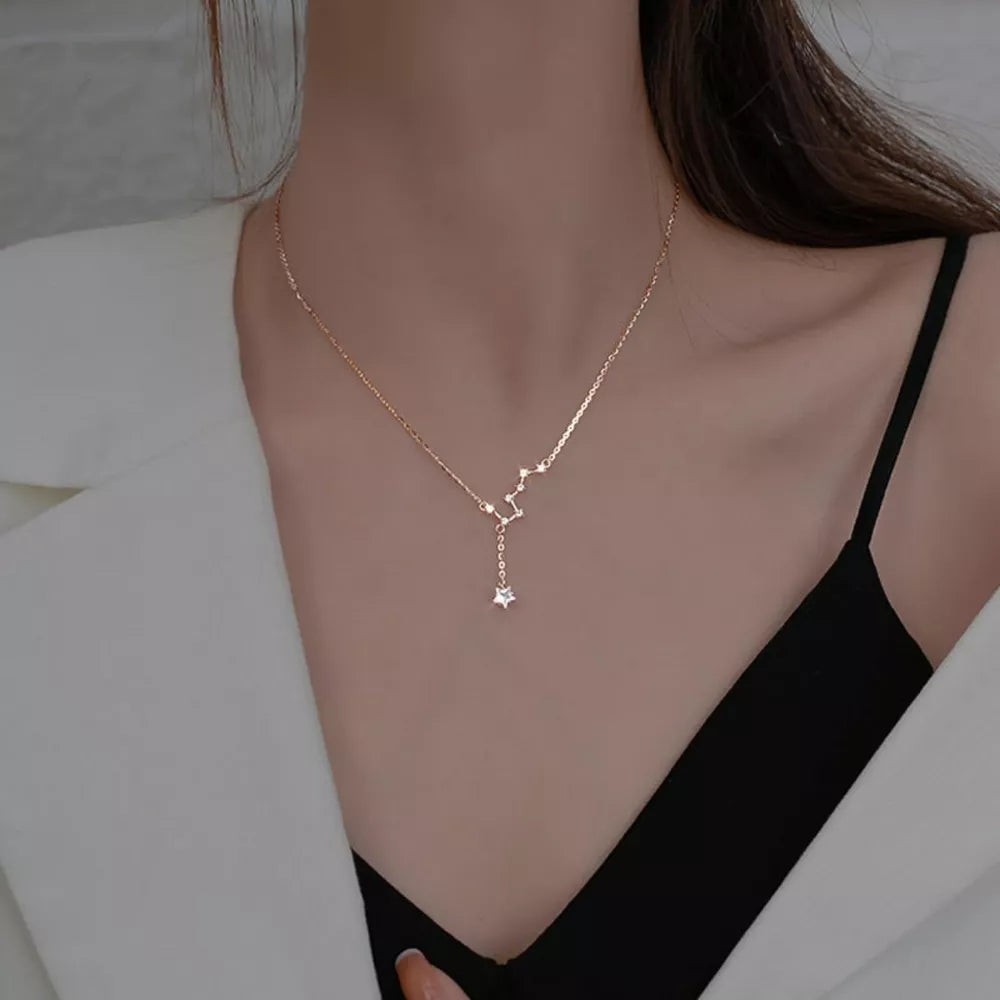 Rose gold sterling silver necklace with constellation and star charm.