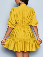Yellow tiered mini dress with cinched waist, puff sleeves, and ruffled hem.