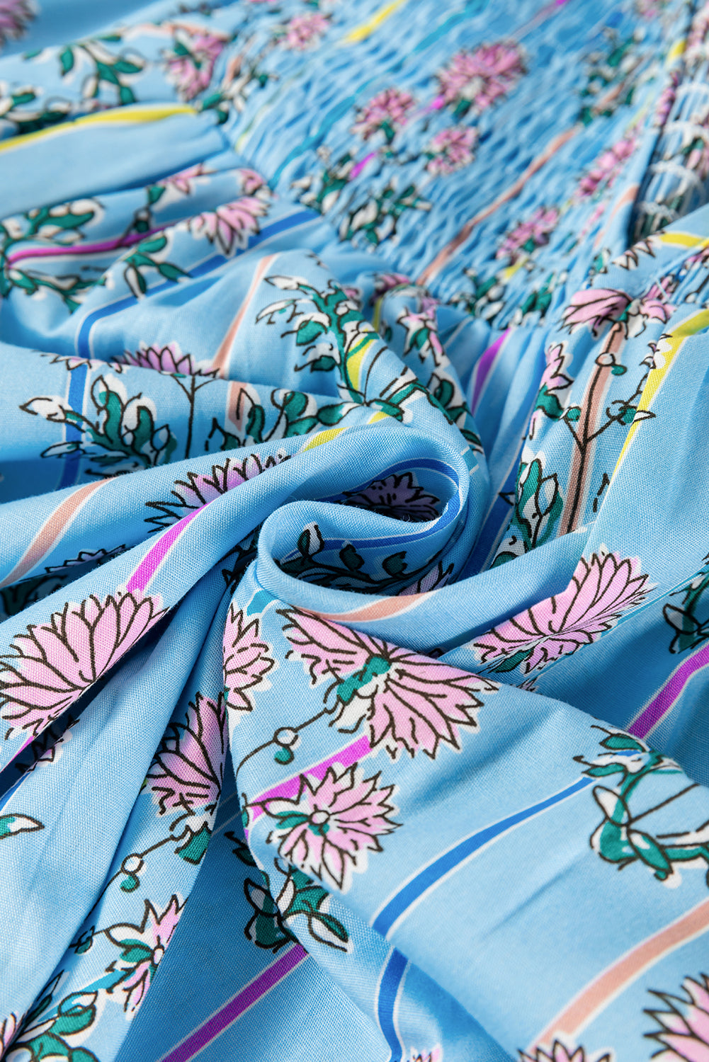 Sky blue floral print smocked yoke blouse with pink flowers and green leaves.