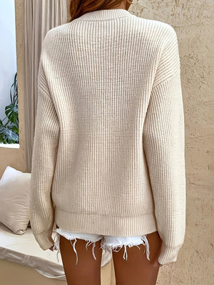 Beige acrylic knit sweater with drop shoulder detail and button placket.