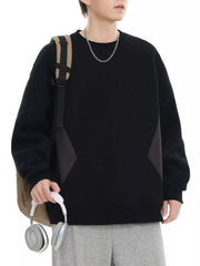 Black oversized cotton crew-neck sweatshirt with dark gray panel details.