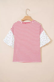 Maternity shirt with red and white stripes and floral patchwork puff sleeves.