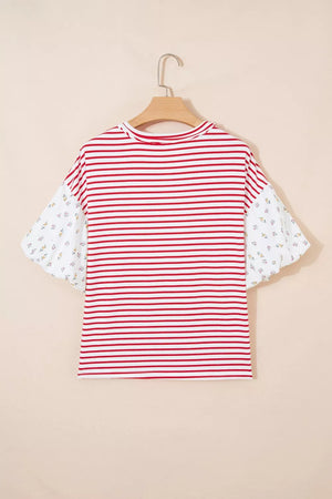 Maternity shirt with red and white stripes and floral patchwork puff sleeves.