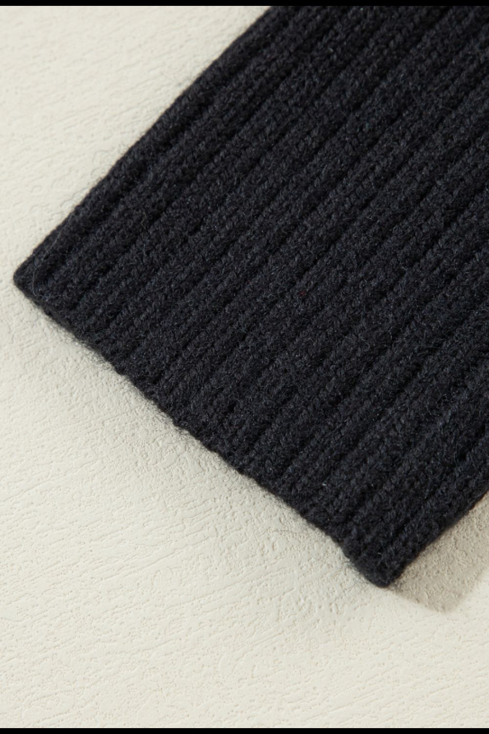 Black acrylic ribbed knit cardigan detail