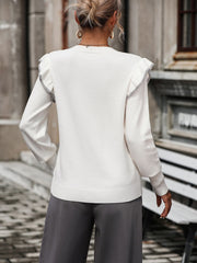 White crew neck sweater with contrast trim ruffle shoulders and long sleeves.