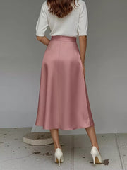 Pink satin A-line midi skirt with pockets, shown from the back.