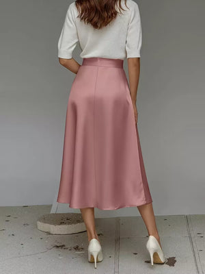 Pink satin A-line midi skirt with pockets, shown from the back.