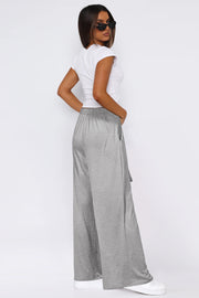 Soft drape palazzo trousers in light gray with a tie detail and elastic waist.