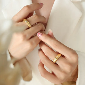 Gold celestial engraved titanium band ring with intricate patterns.