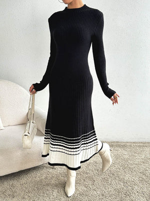 Black ribbed knit midi dress with contrast striped hem and long sleeves.