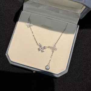 Elegant silver necklace with butterfly charms and a dangling zircon, made of 925 sterling silver.