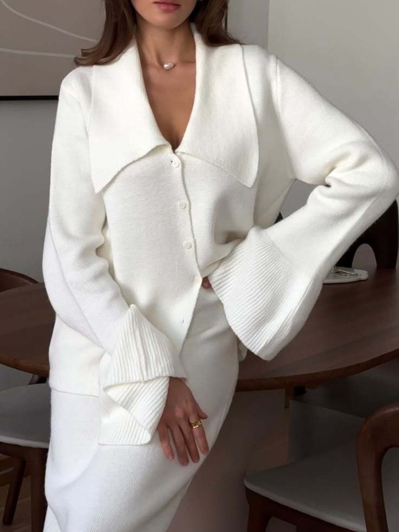 Milky white ribbed knit cardigan with wide collar and flared sleeves, paired with a matching skirt.