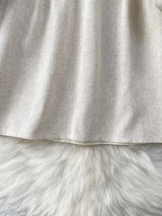 Cream tie-neck blouse with textured fabric and delicate embroidery detail