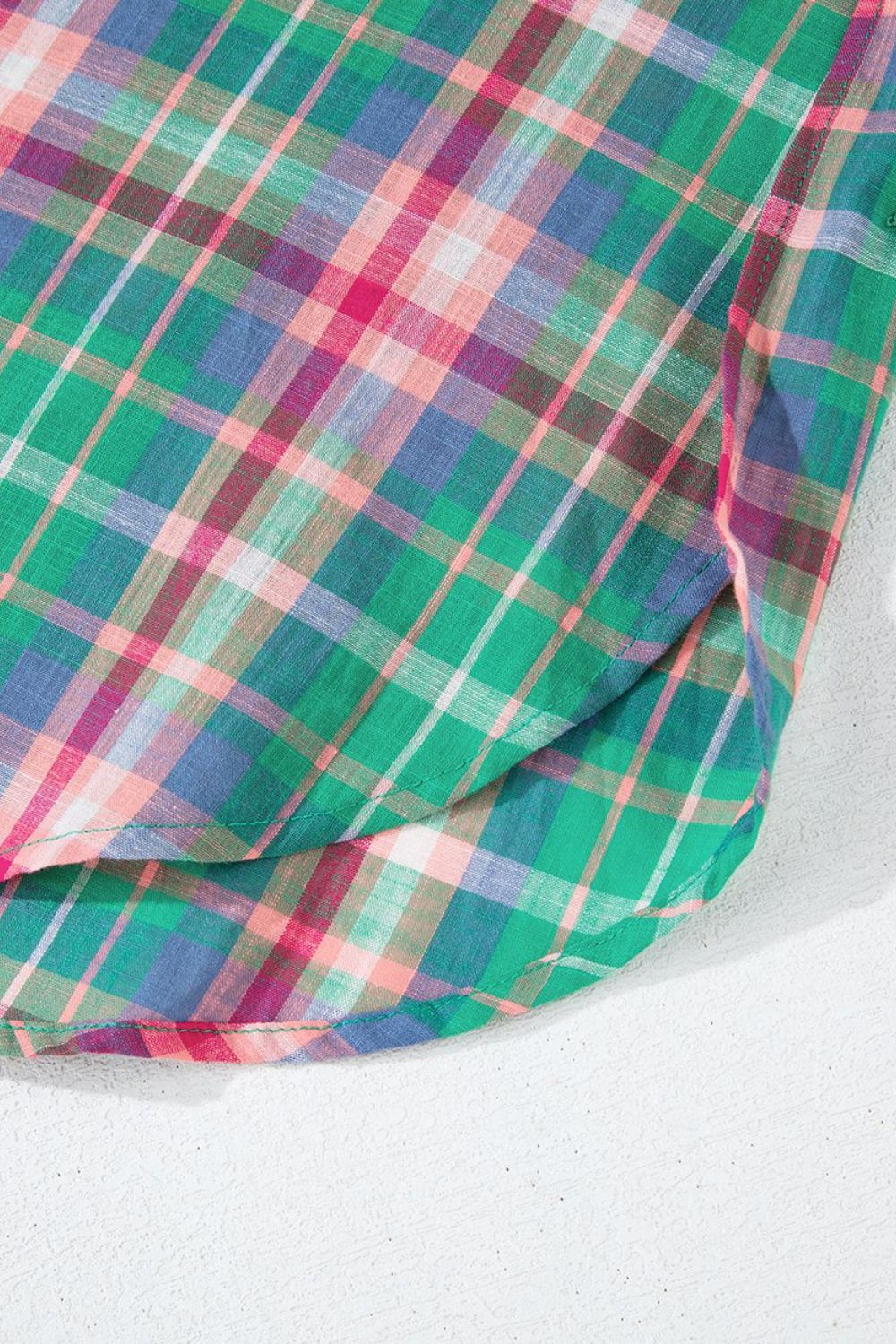Voluminous plaid blouse with gathered sleeves in green, pink, and blue plaid fabric.