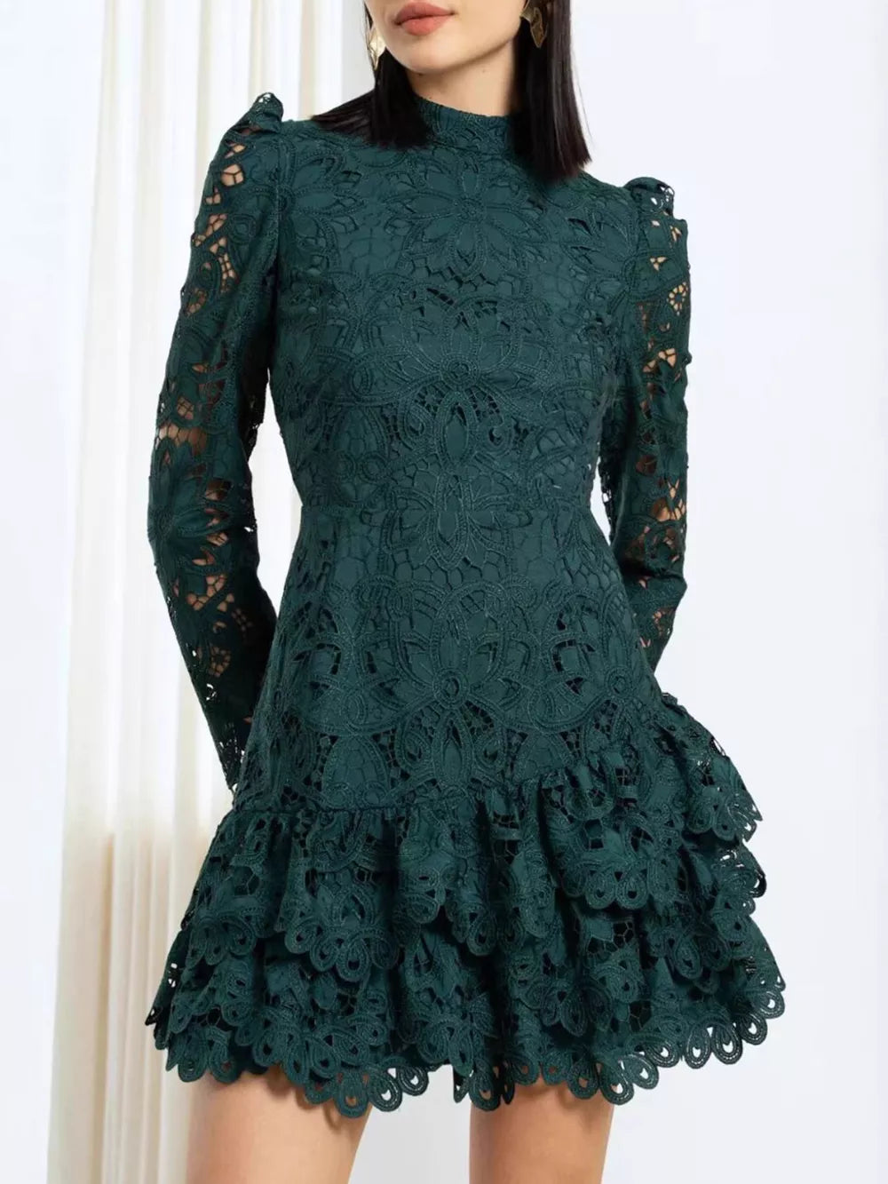 Dark green lace mock neck mini dress with ruffled tiered skirt and puff sleeves.