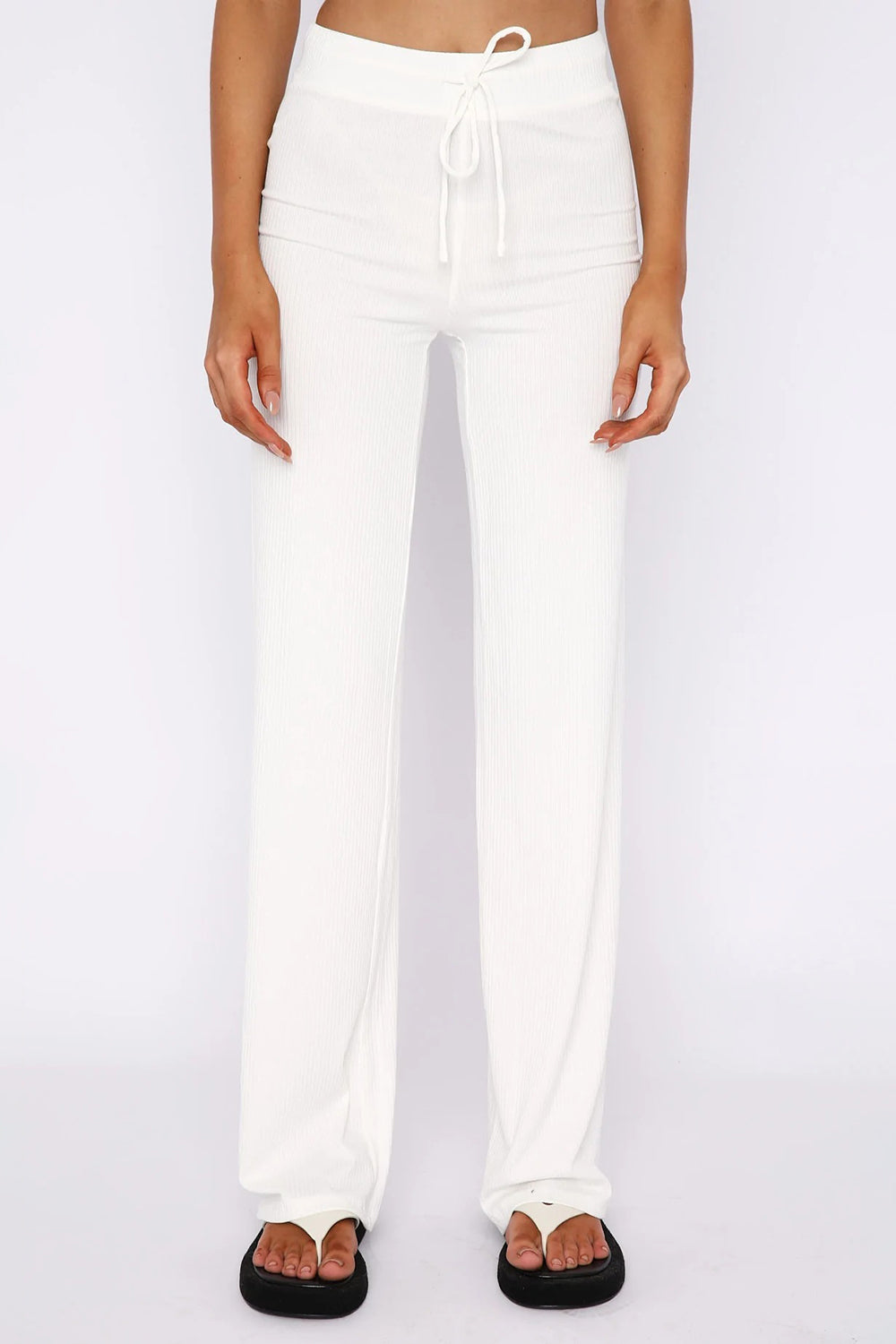 White ribbed wide leg pants with drawstring waist, styled with platform flip-flops.
