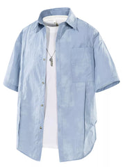 Men's blue short sleeve buttoned shirt with pocket detail over white undershirt.