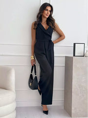 Black wrap-front wide-leg romper with belted waist and V-neck.