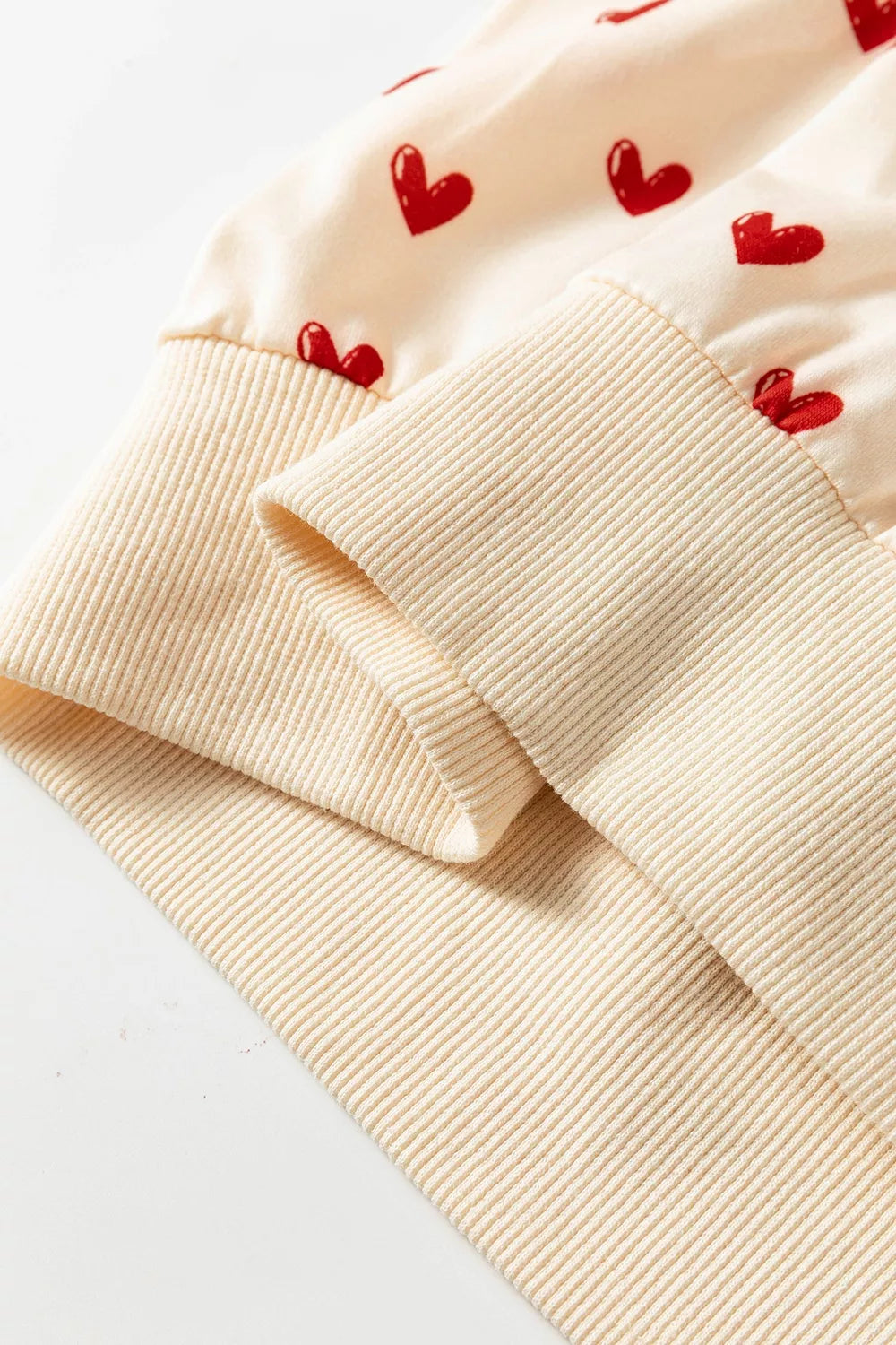 Heart Print Round Neck Long Sleeve Sweatshirt in Cream, fit detail