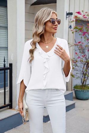 White V-neck flutter sleeve blouse with ruffled front detail.