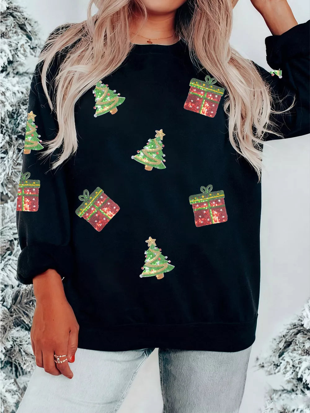 Black crew neck sweatshirt with sequin Christmas tree and gift embellishments.