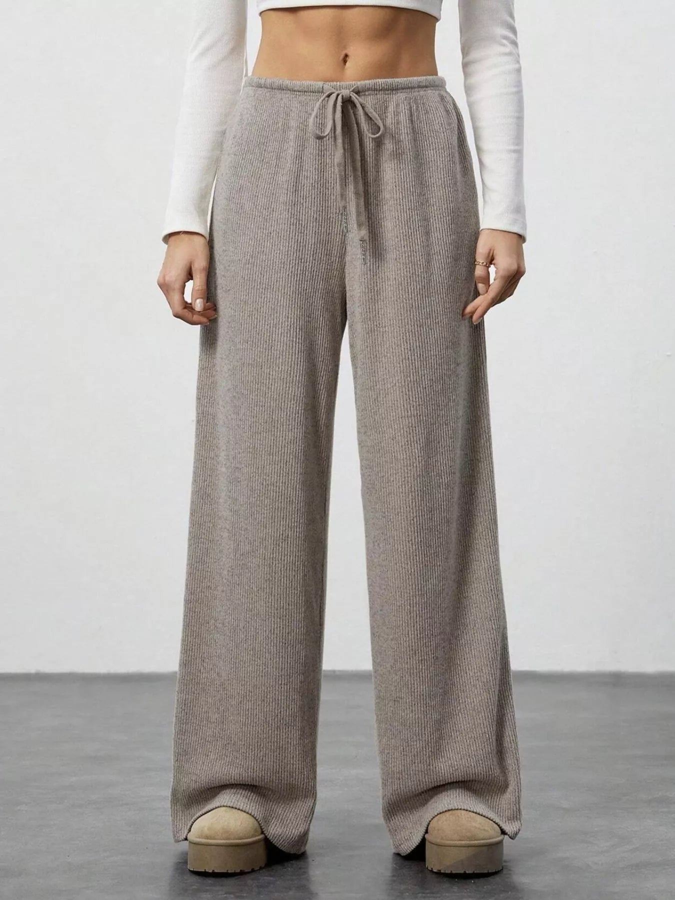 Relaxed wide-leg pants in mocha ribbed knit with drawstring waist.
