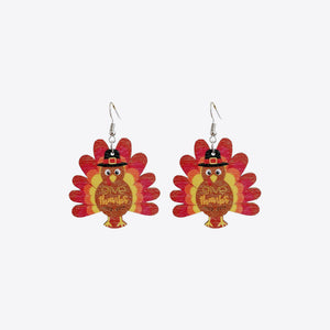 Thanksgiving turkey dangle earrings with black hats and "give thanks" text.
