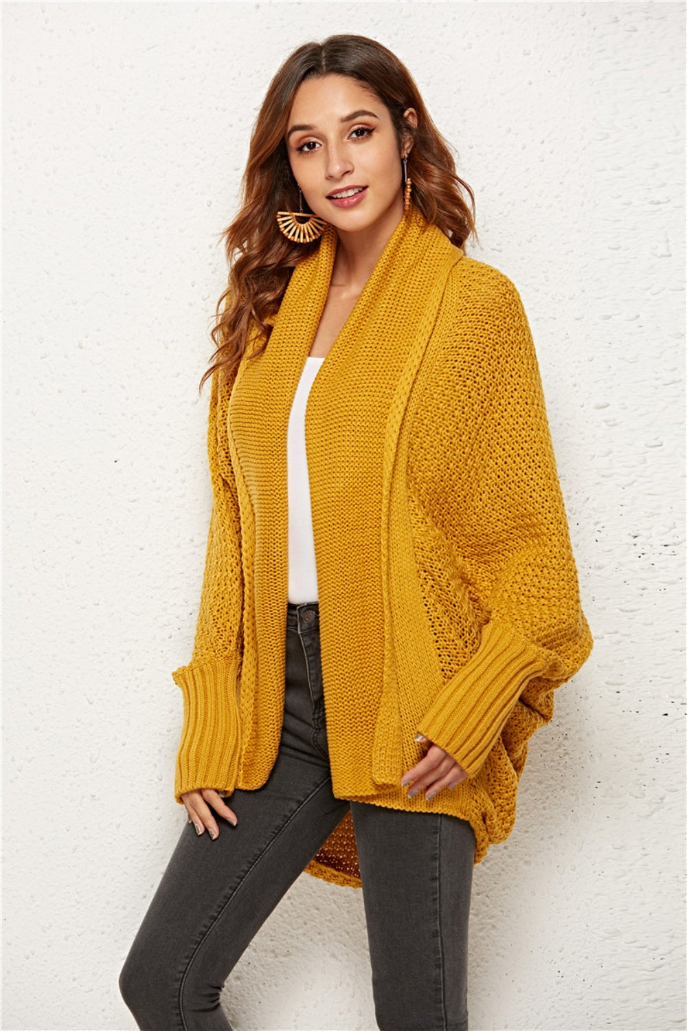 Textured cocoon knit cardigan in gold with batwing sleeves and open front.