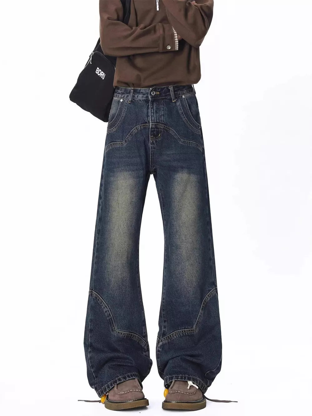 Men's vintage wash wide leg jeans with distressed details and a relaxed fit.