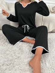 Black lounge set with contrast trim, V-neck top and drawstring pants.